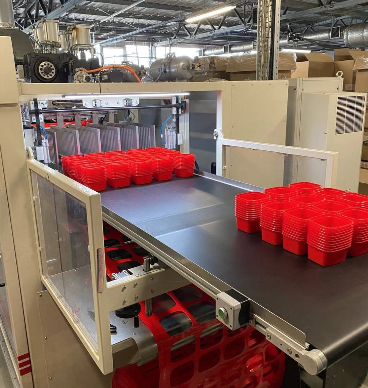 Thermoforming line: finished containers coming off the conveyor